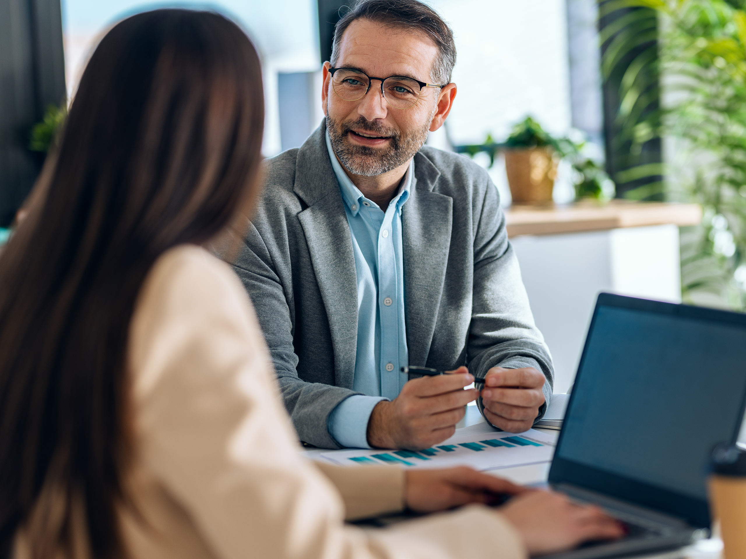 Two business people discuss developing a new insurance product