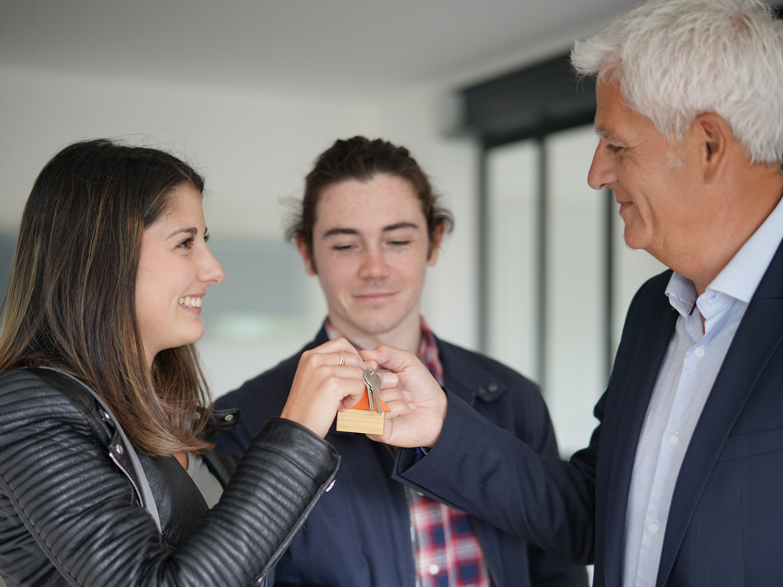 Landlord hands keys to new tenants