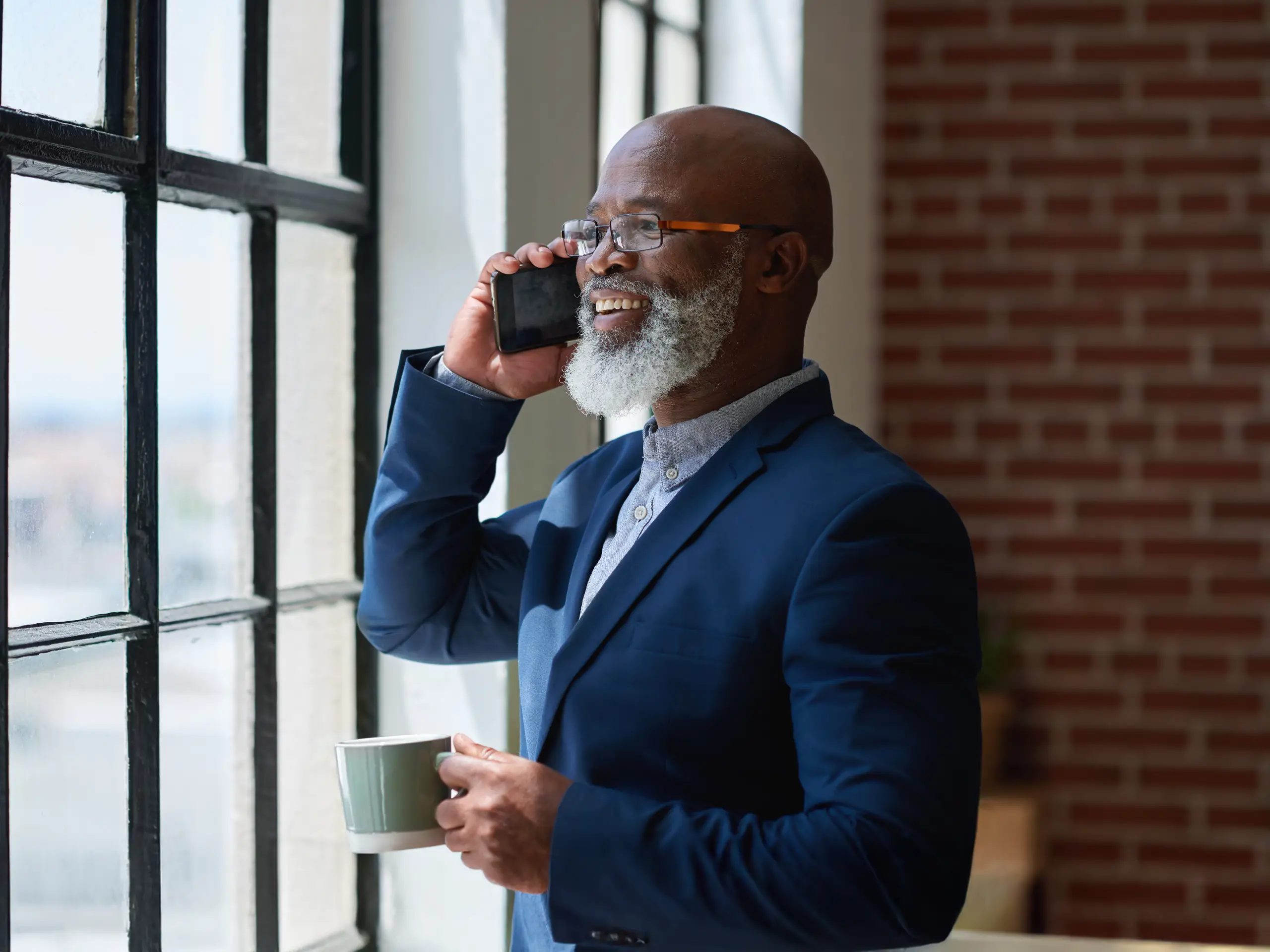 Mid age businessman talking at mobile phone