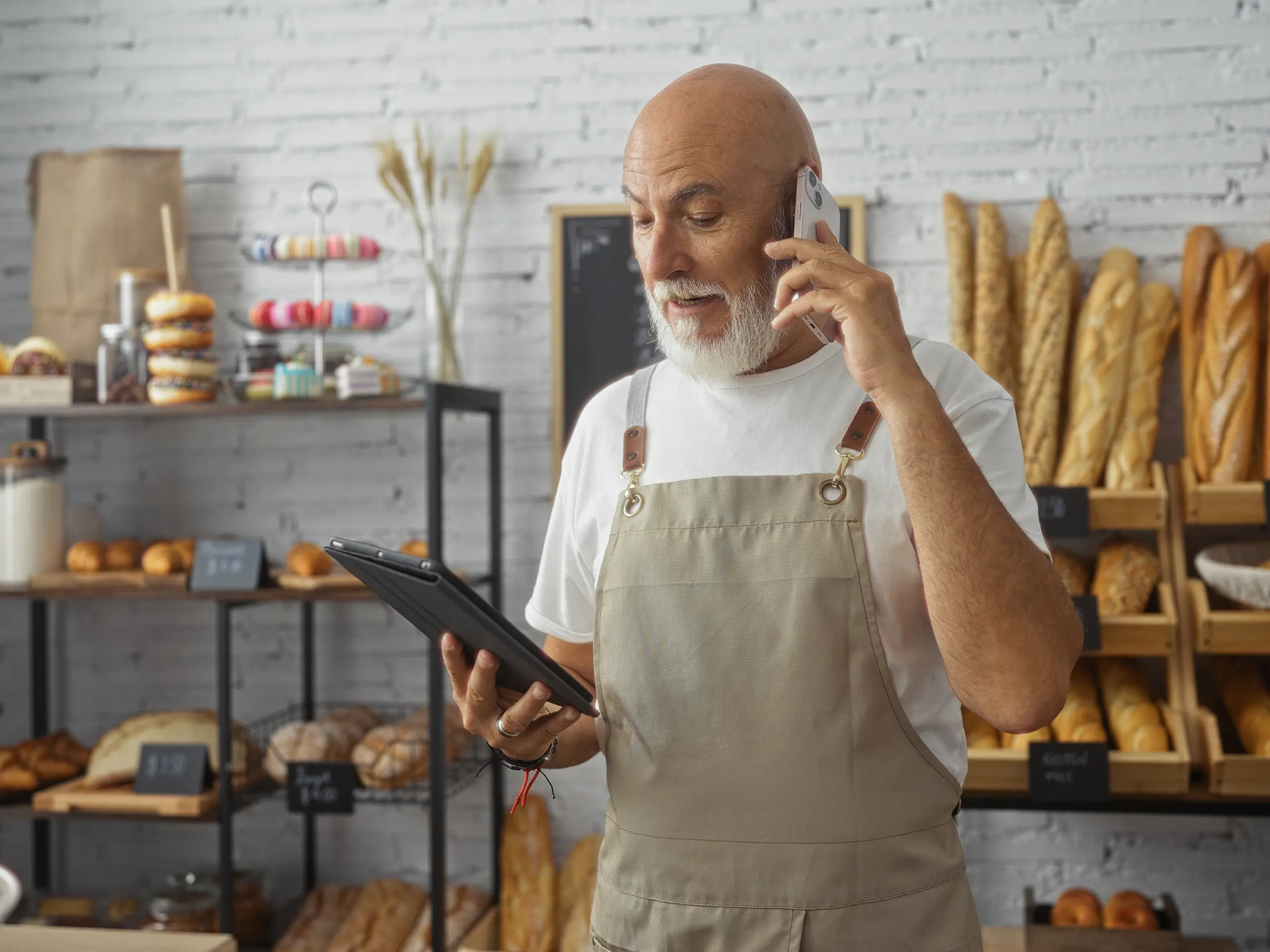 Baker looking at notes, talking at phone, bread, chef