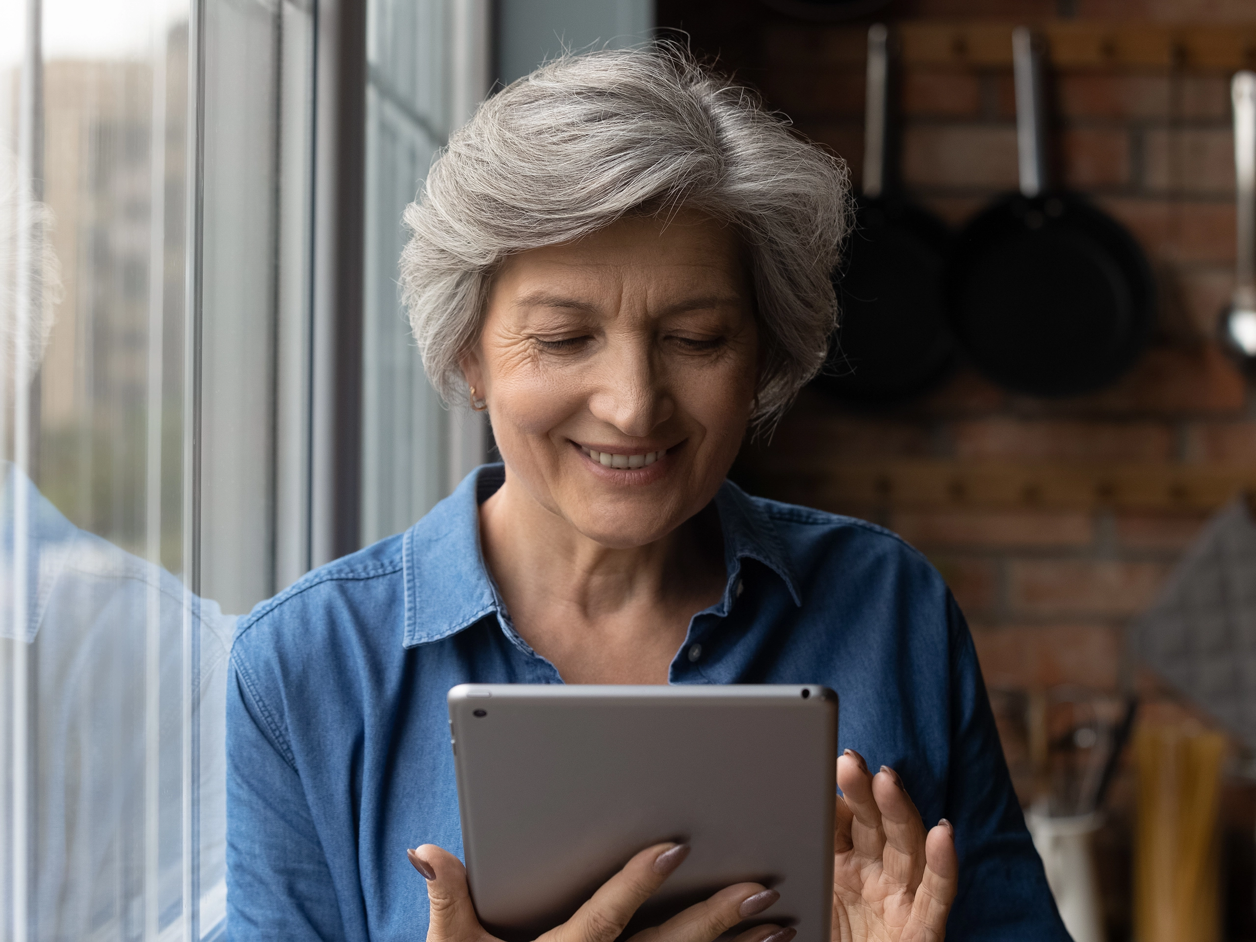 Woman smiling and looking at tablet