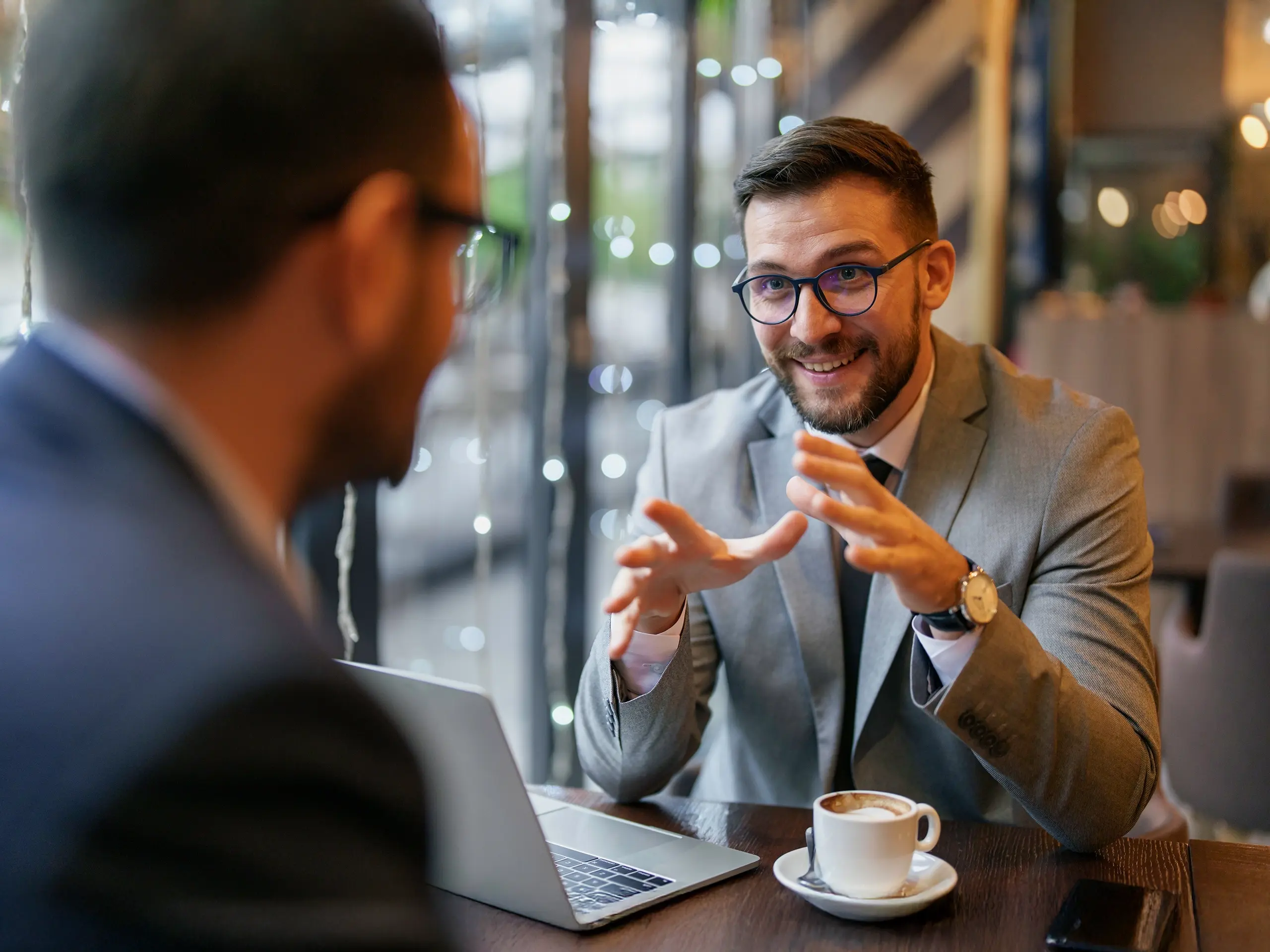 two businessmen in a meeting while having a hot drink
