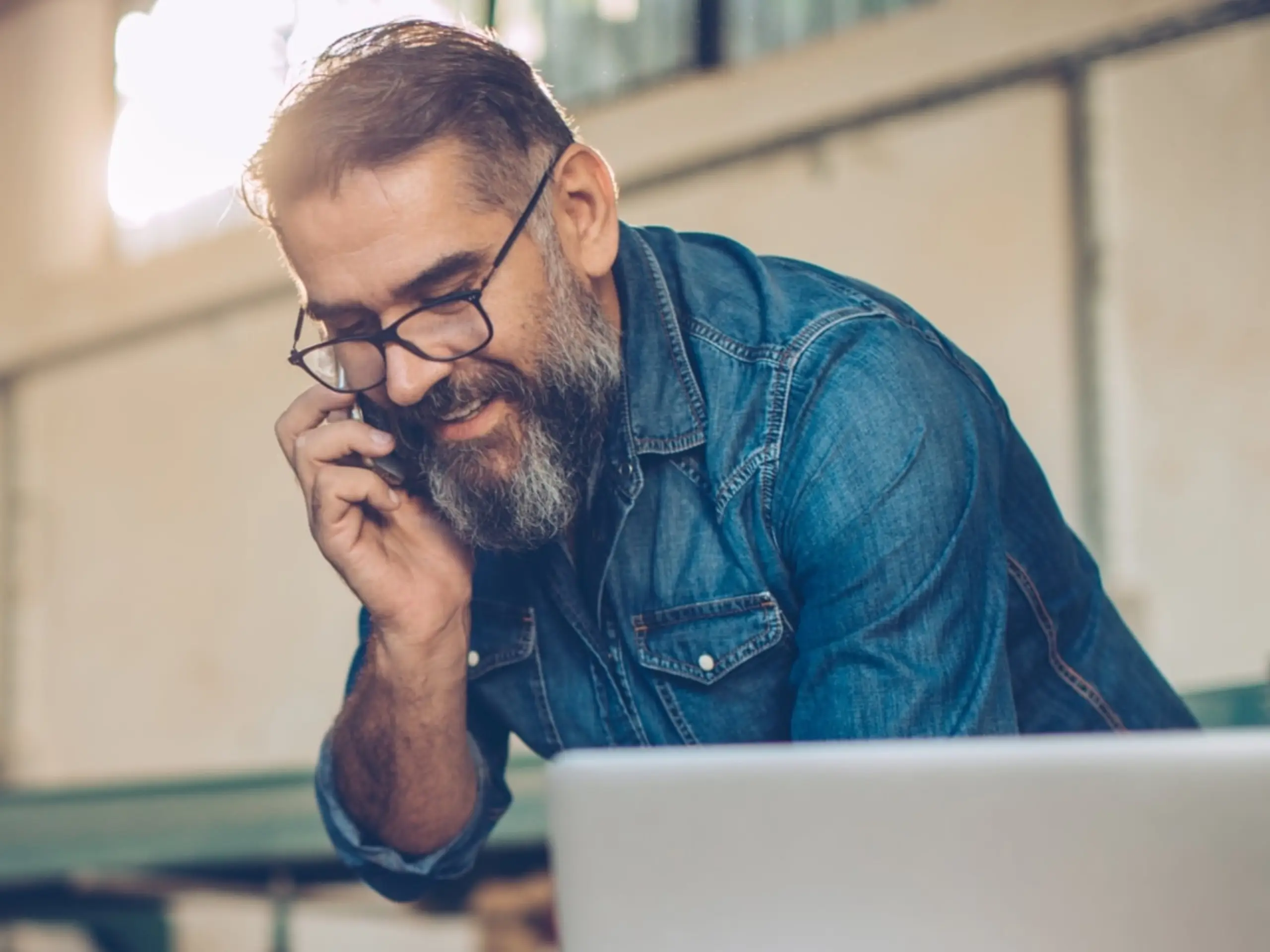Man with glasses on the phone