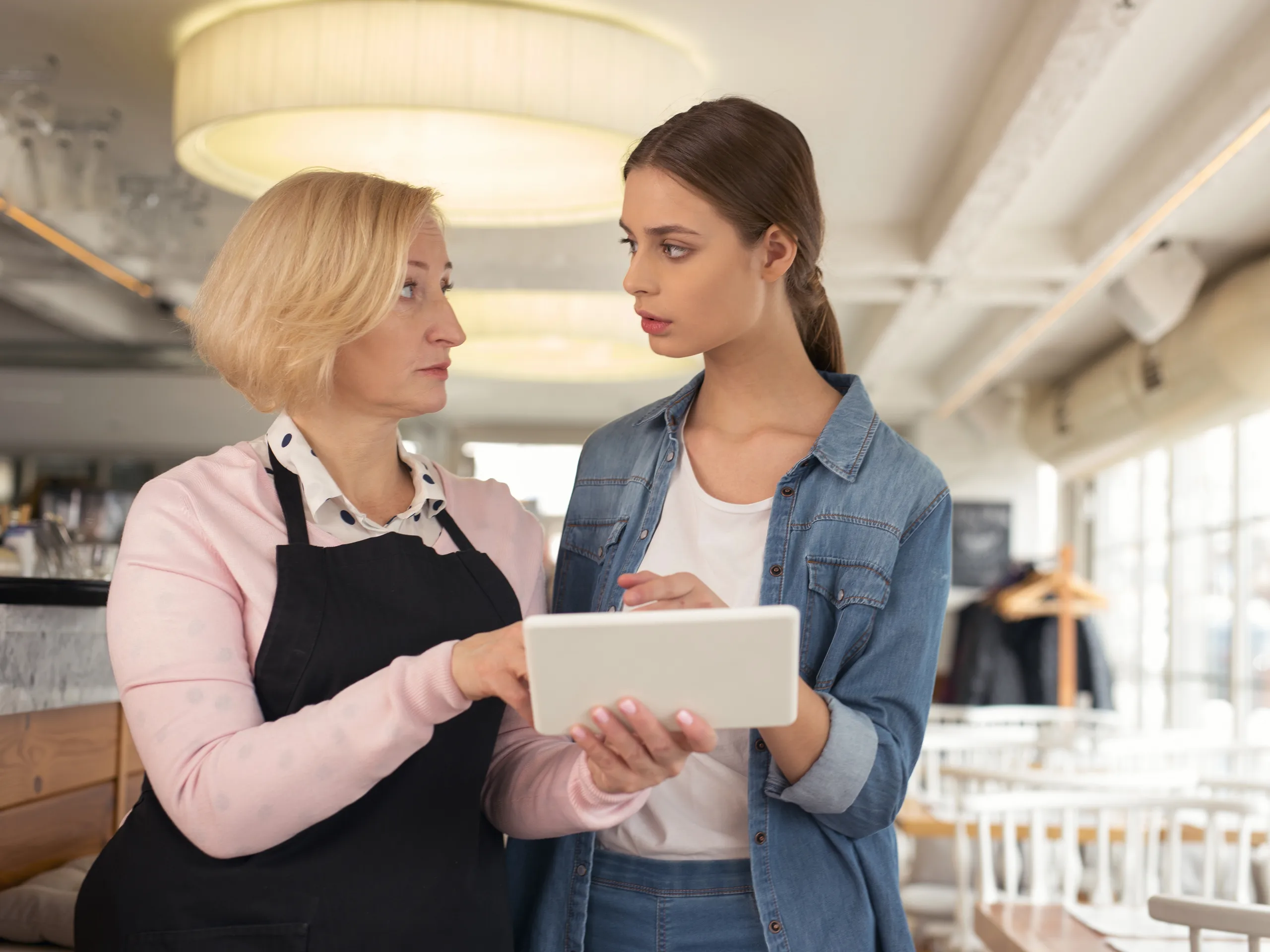 Female employer talking to her staff member with concernes