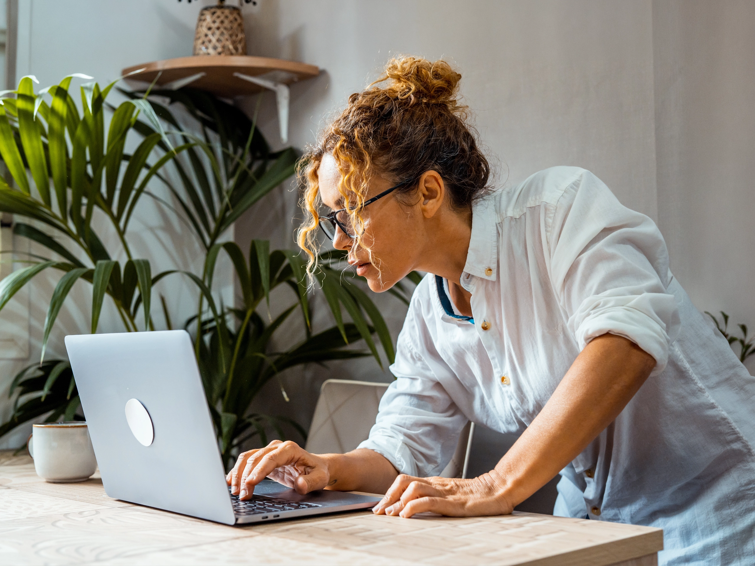 Woman at her desk checking the claim on her laptop