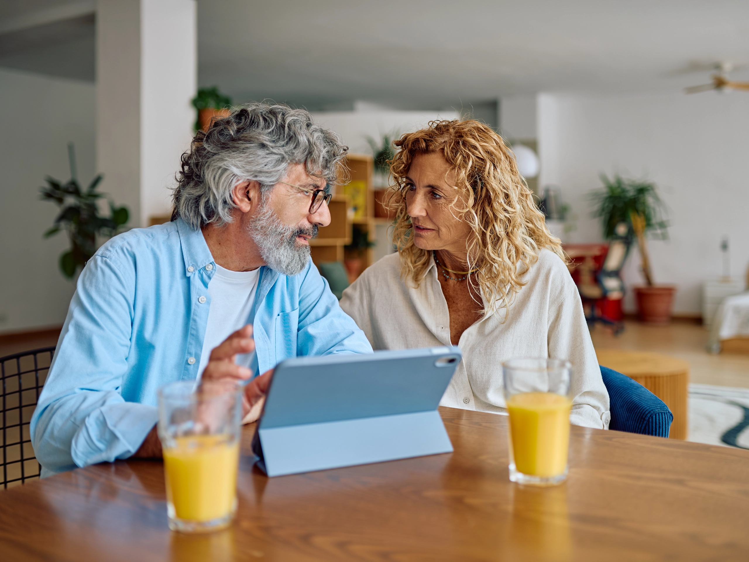couple sitting at the kitchen table talking about their claim