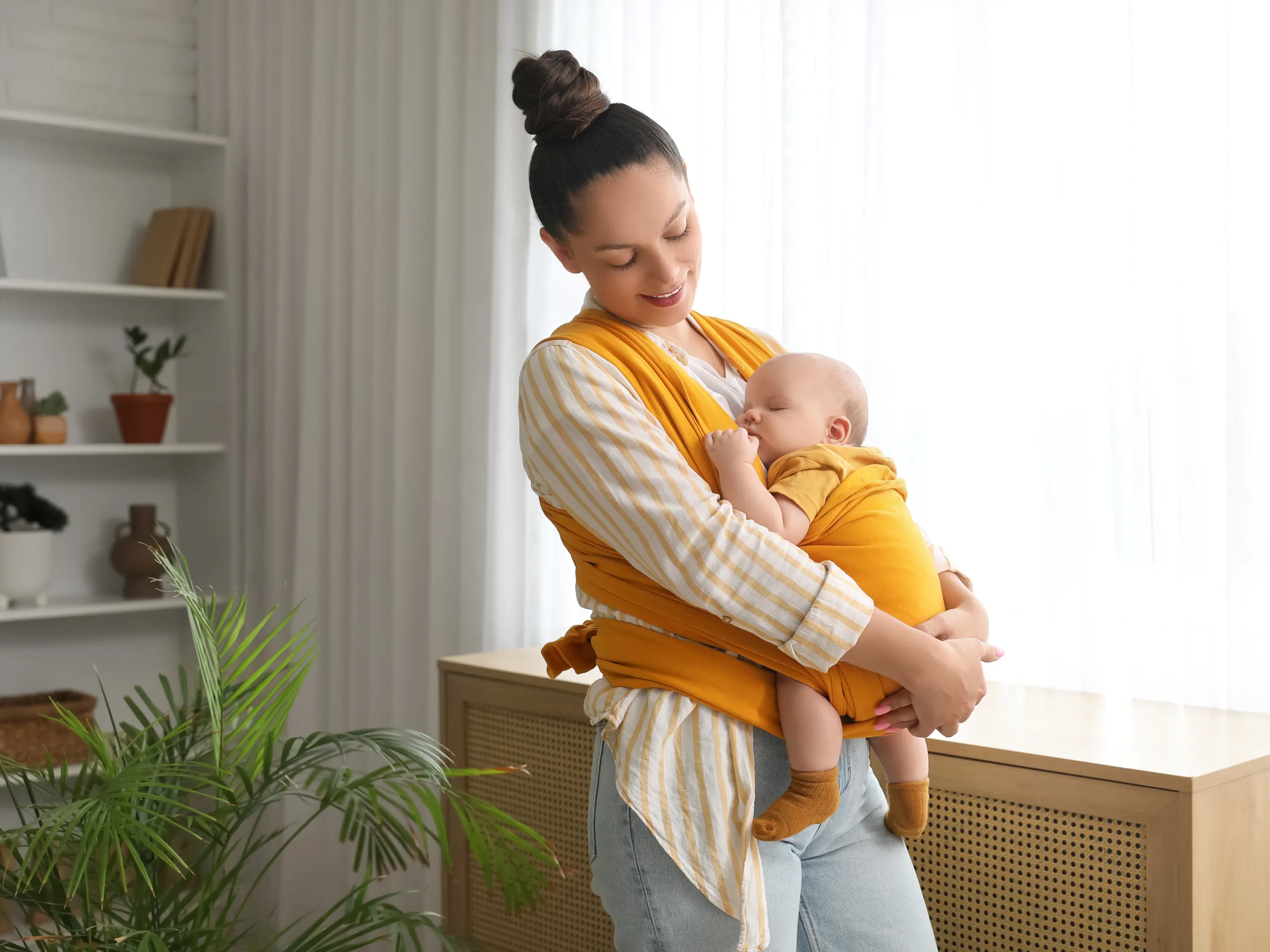 Woman standing holding her baby