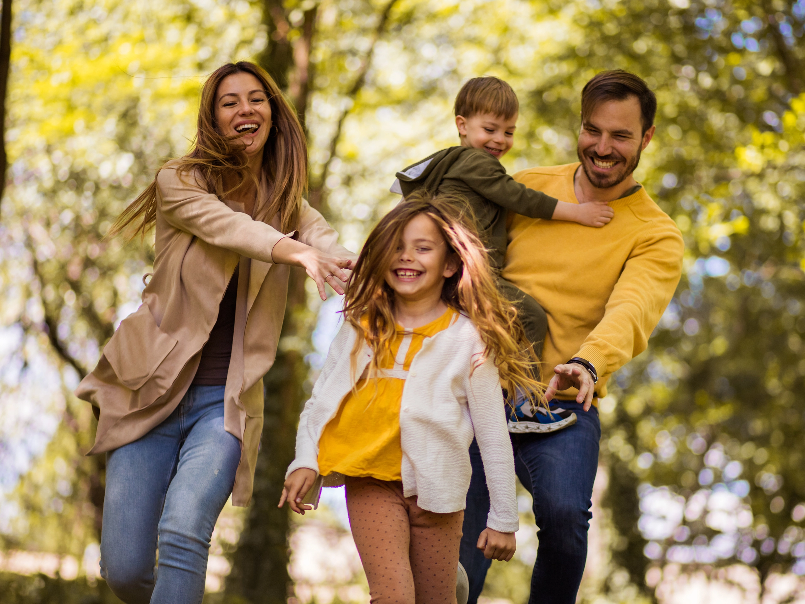 Happy family running in park