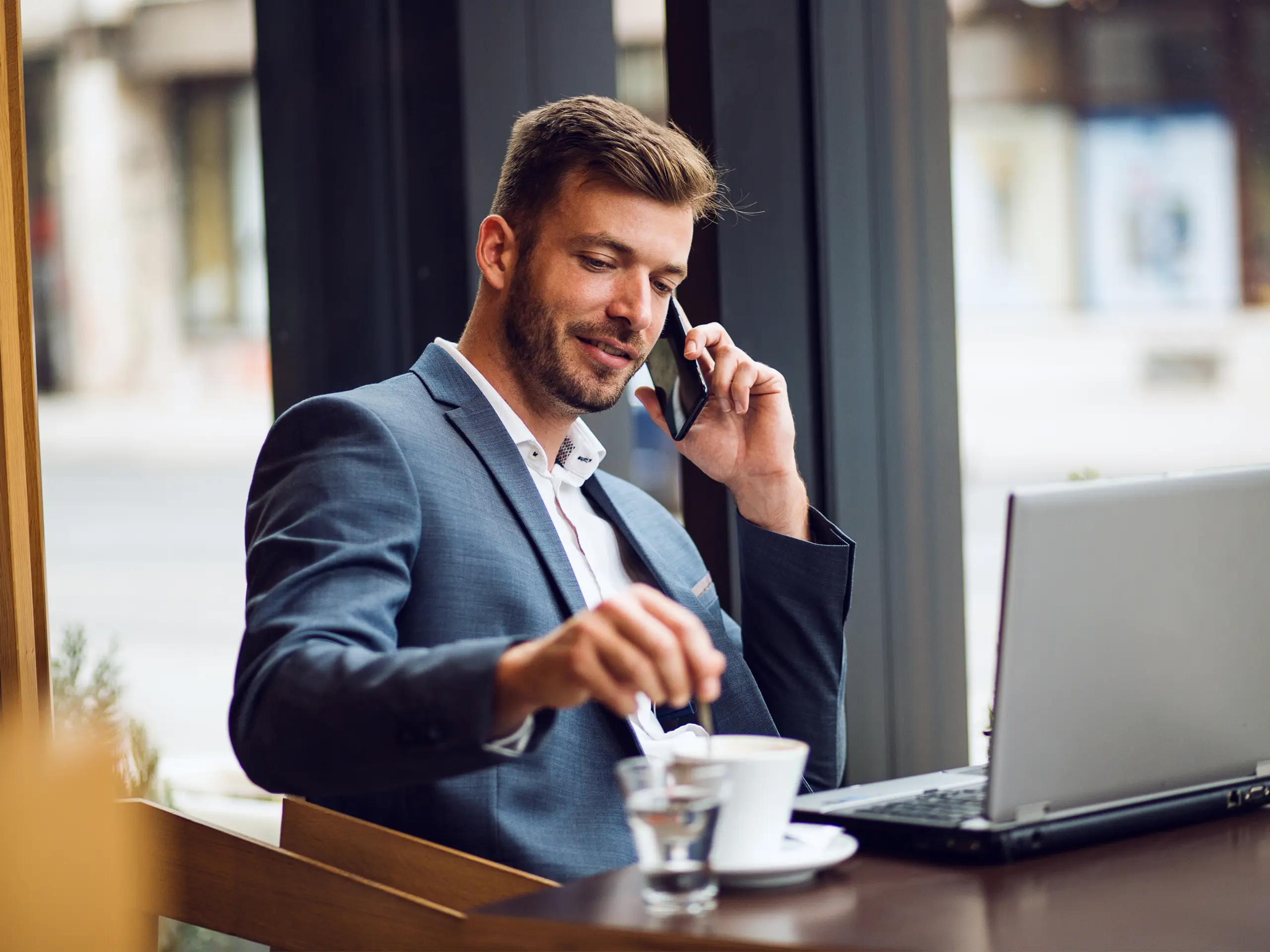 Business man talking at phone, hot drink, ATE