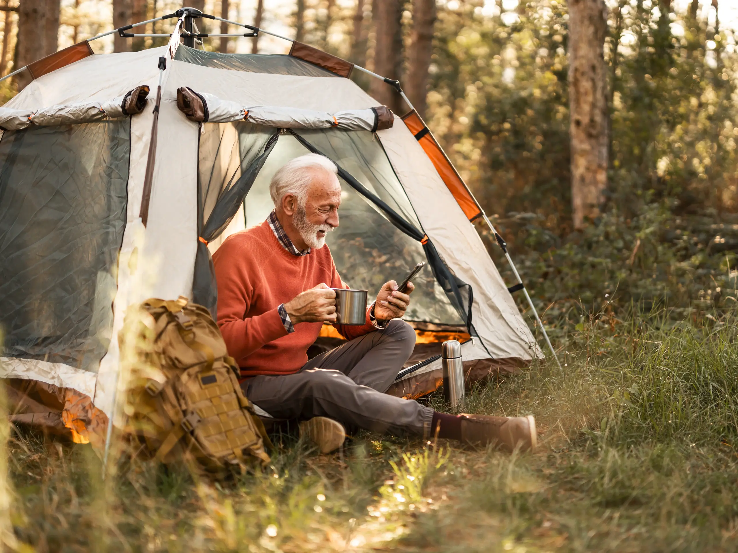 Customer purchased a tent, having a hot drink, looking at phone