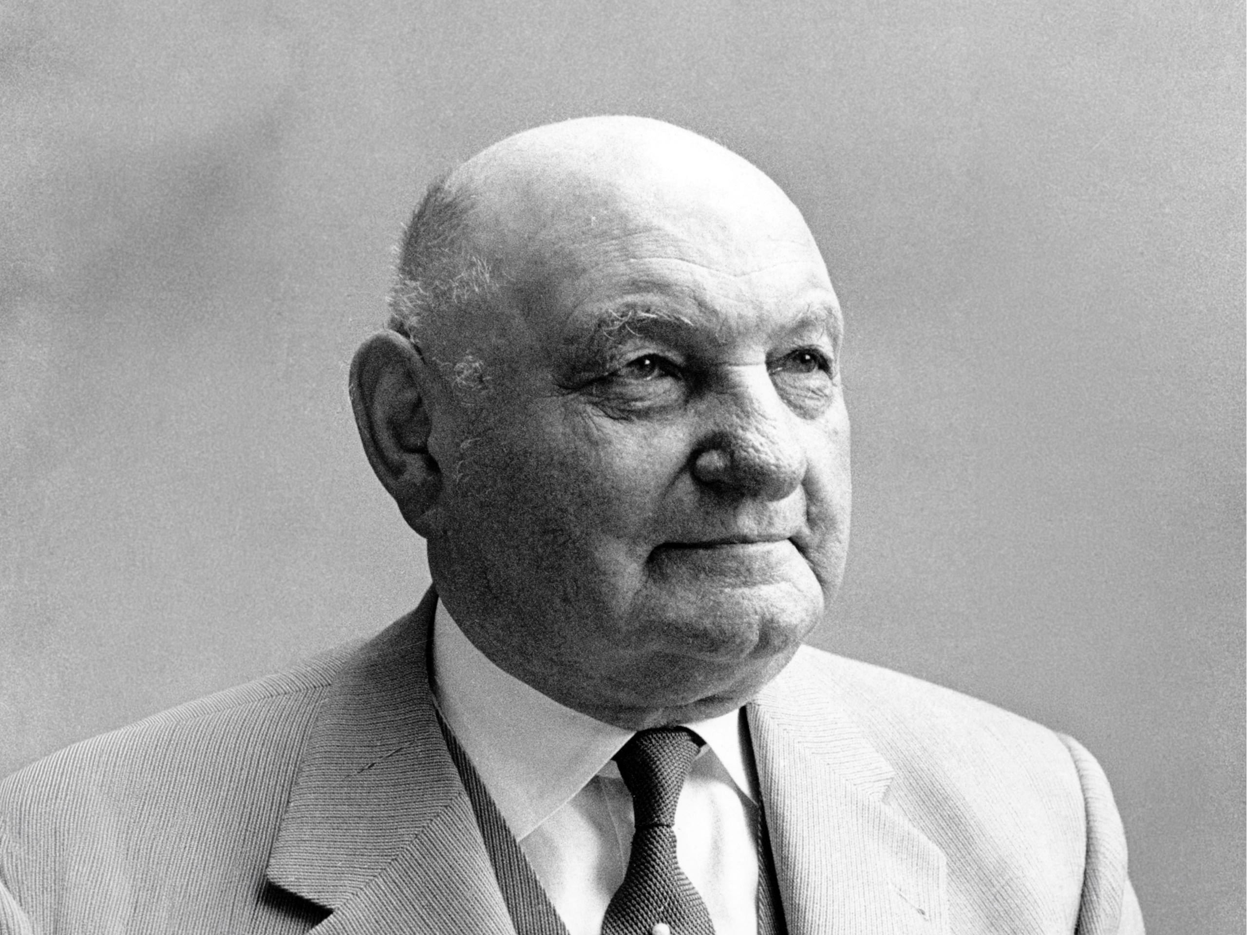 A profile image of an older man in black and white
