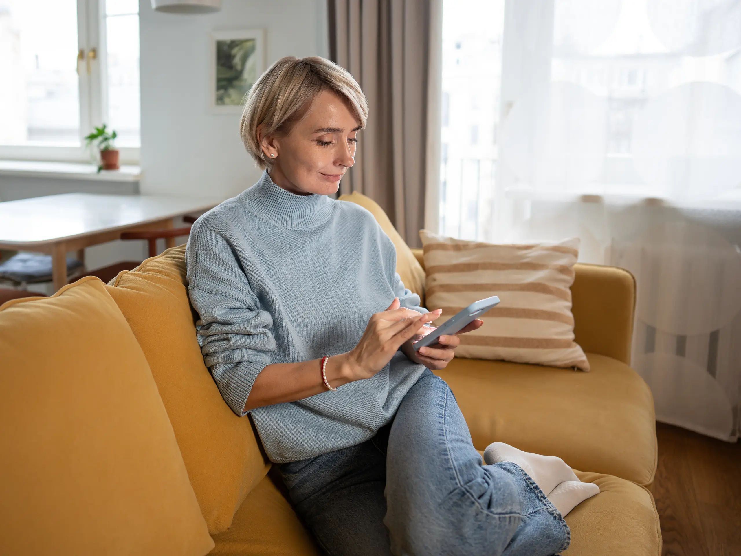 Woman on sofa looking at her phone