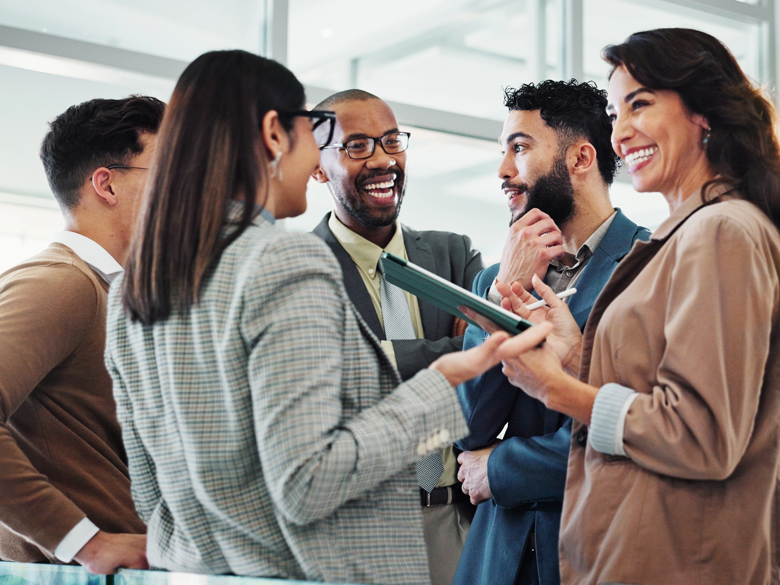 People, happy and meeting in lobby for business, positive feedback and discussion with tablet. Employees, excited and chat in office for company news