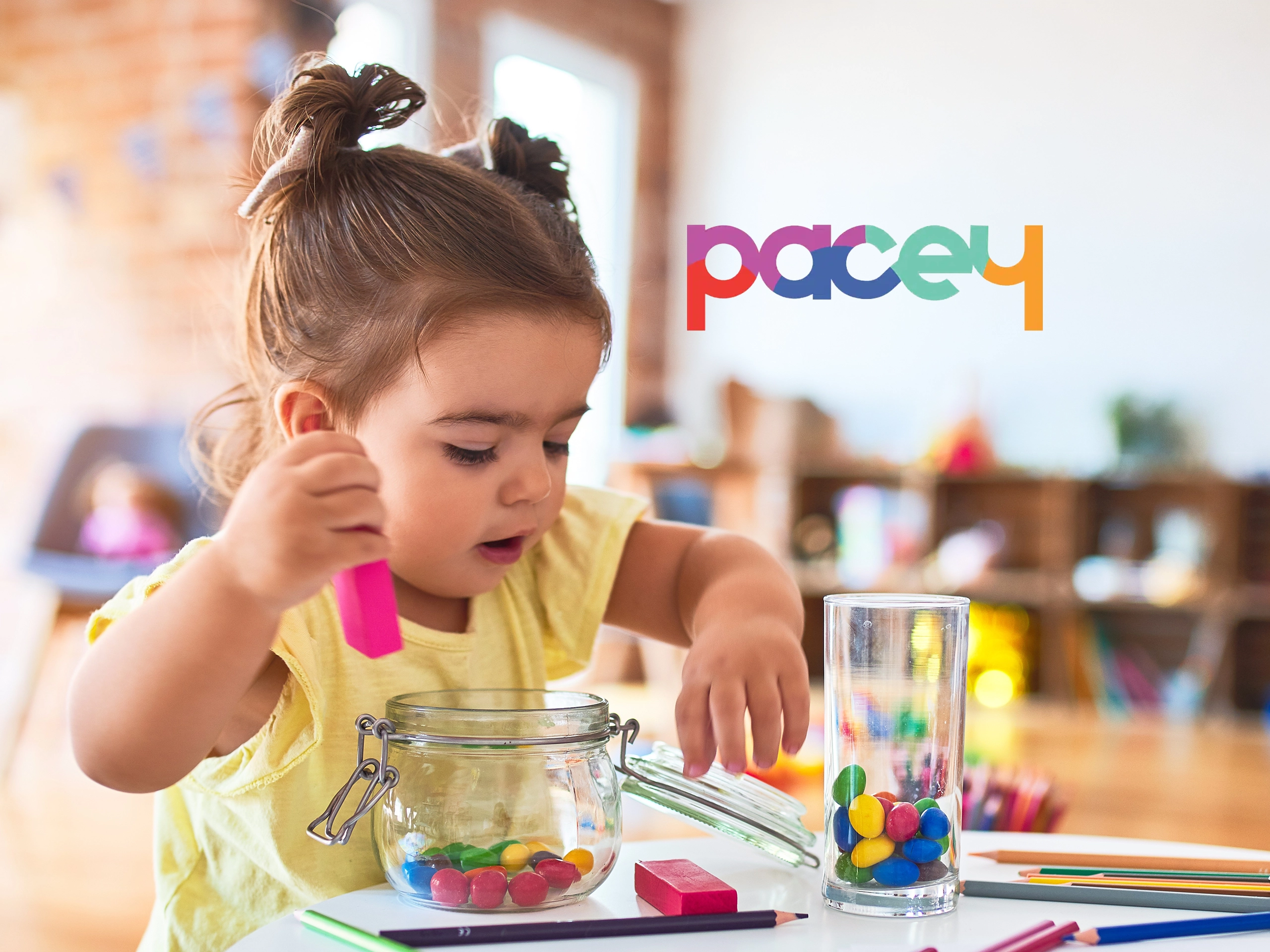 Young girl playing with coloured stones in a kindergarden setting