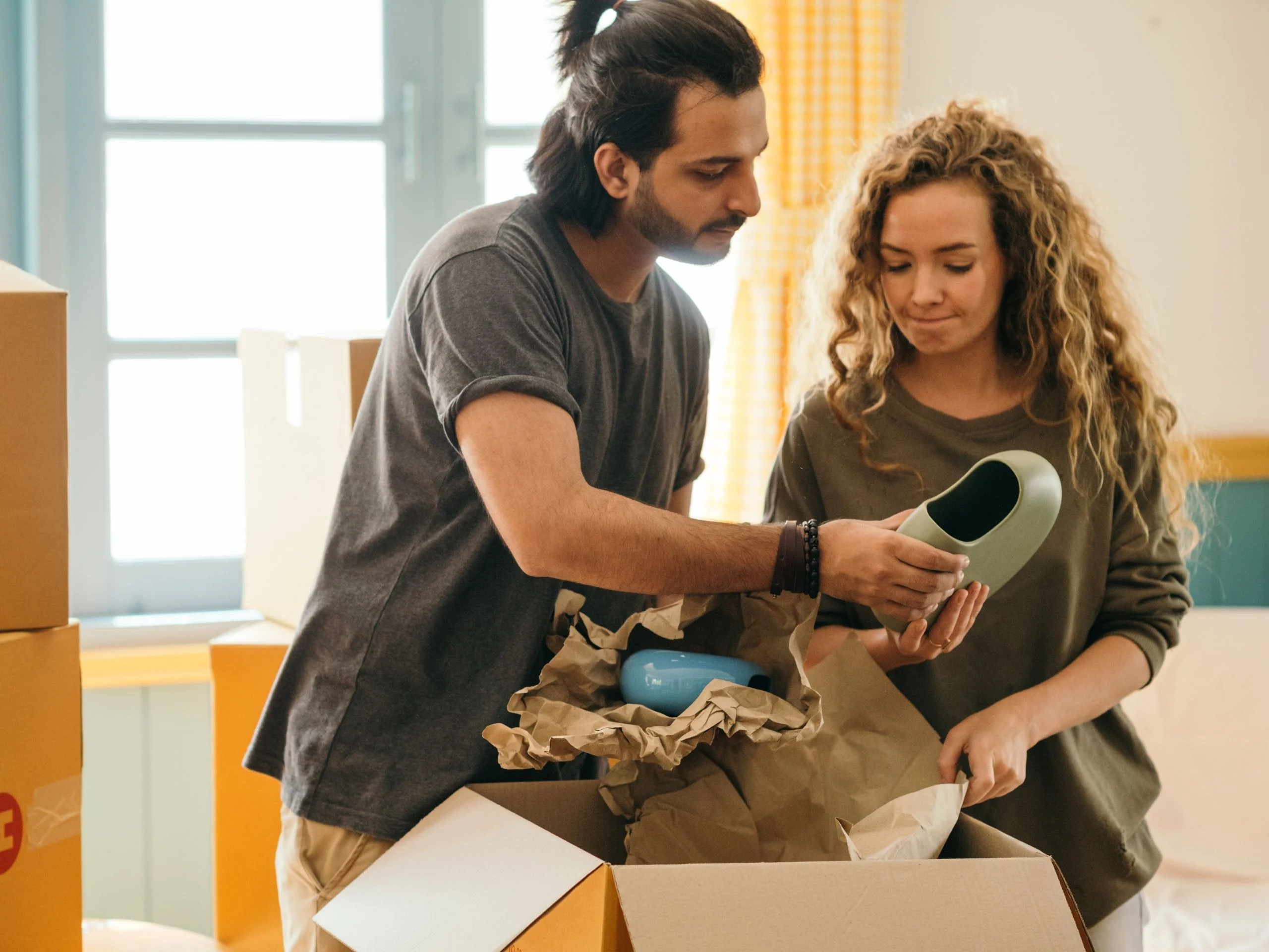 Couple of people renting, taking items out of boxes