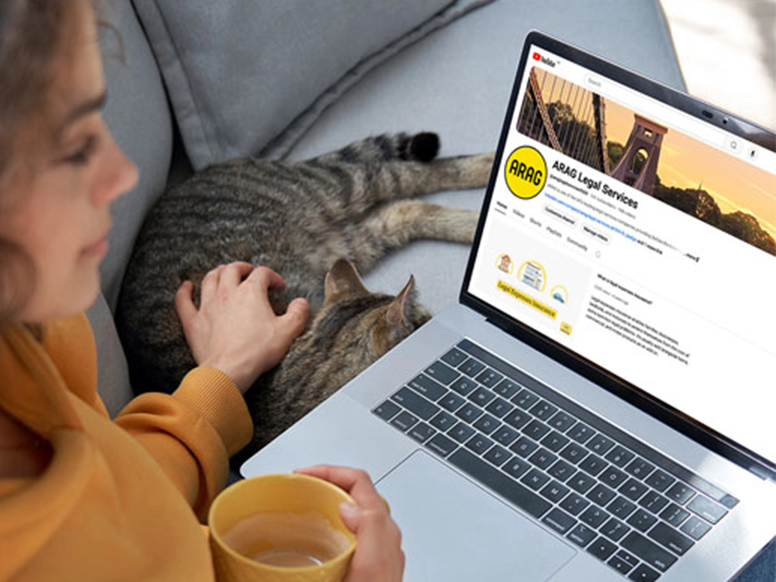 Woman looking at laptop screen on ARAG's Youtube channel