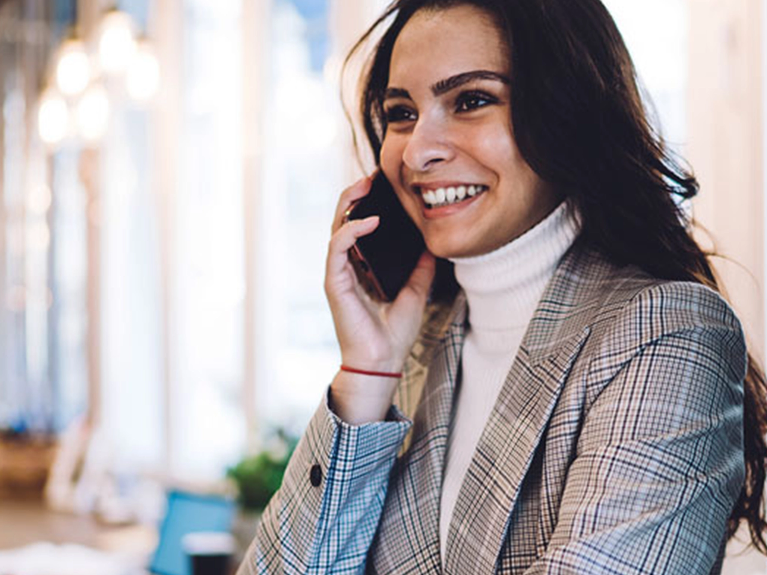 Smart business woman on the phone looking happy