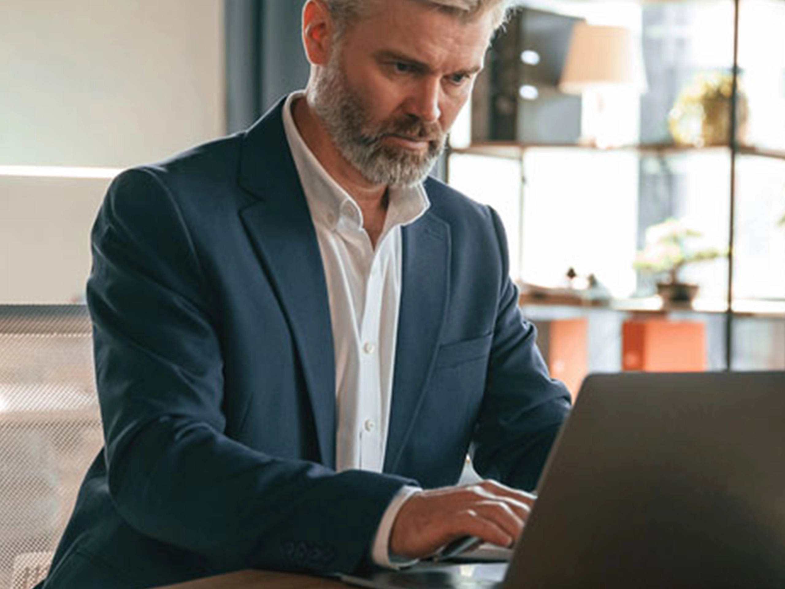 Business man working on laptop looking focused