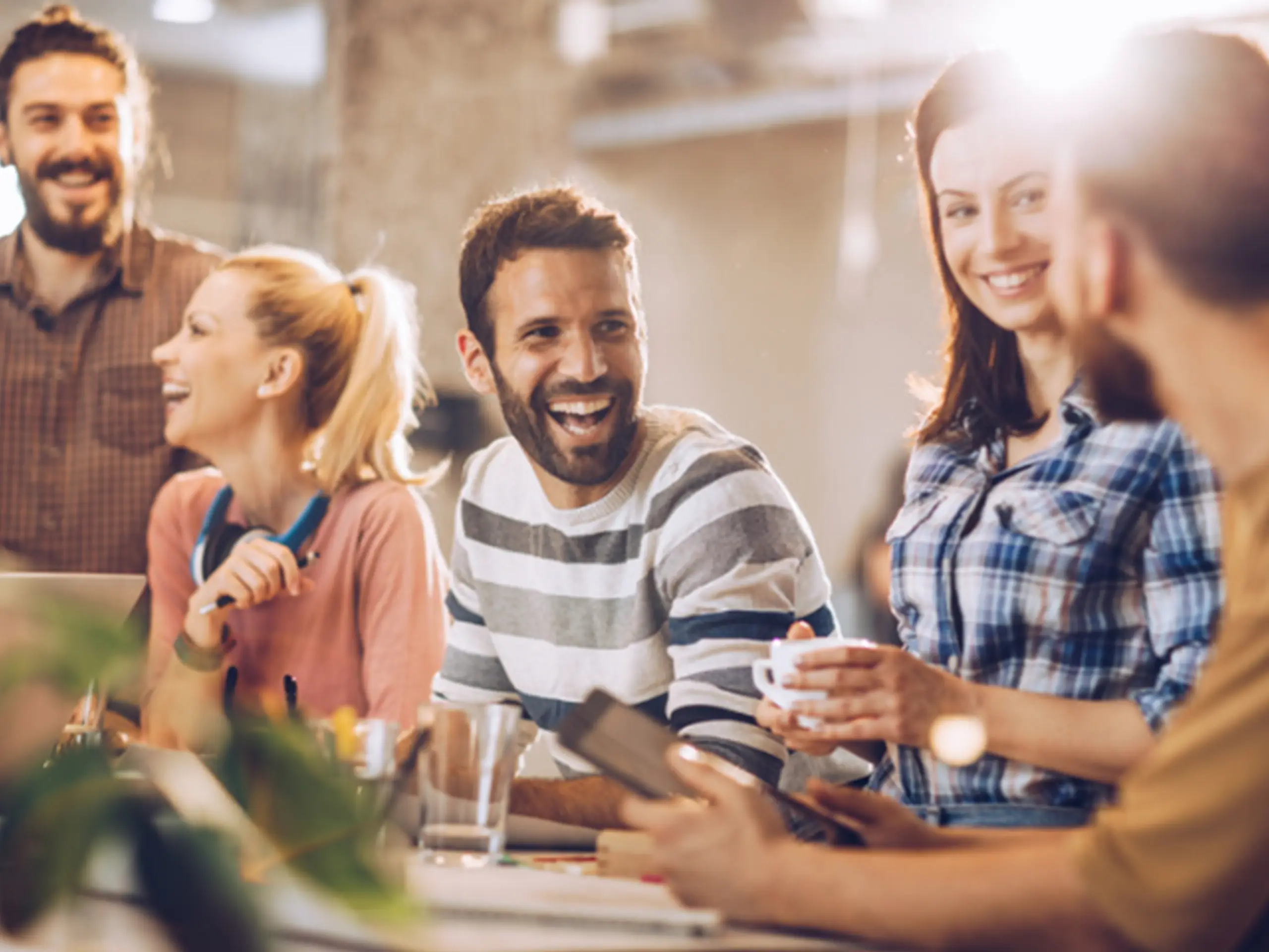 Group of coworkers around a table chatting