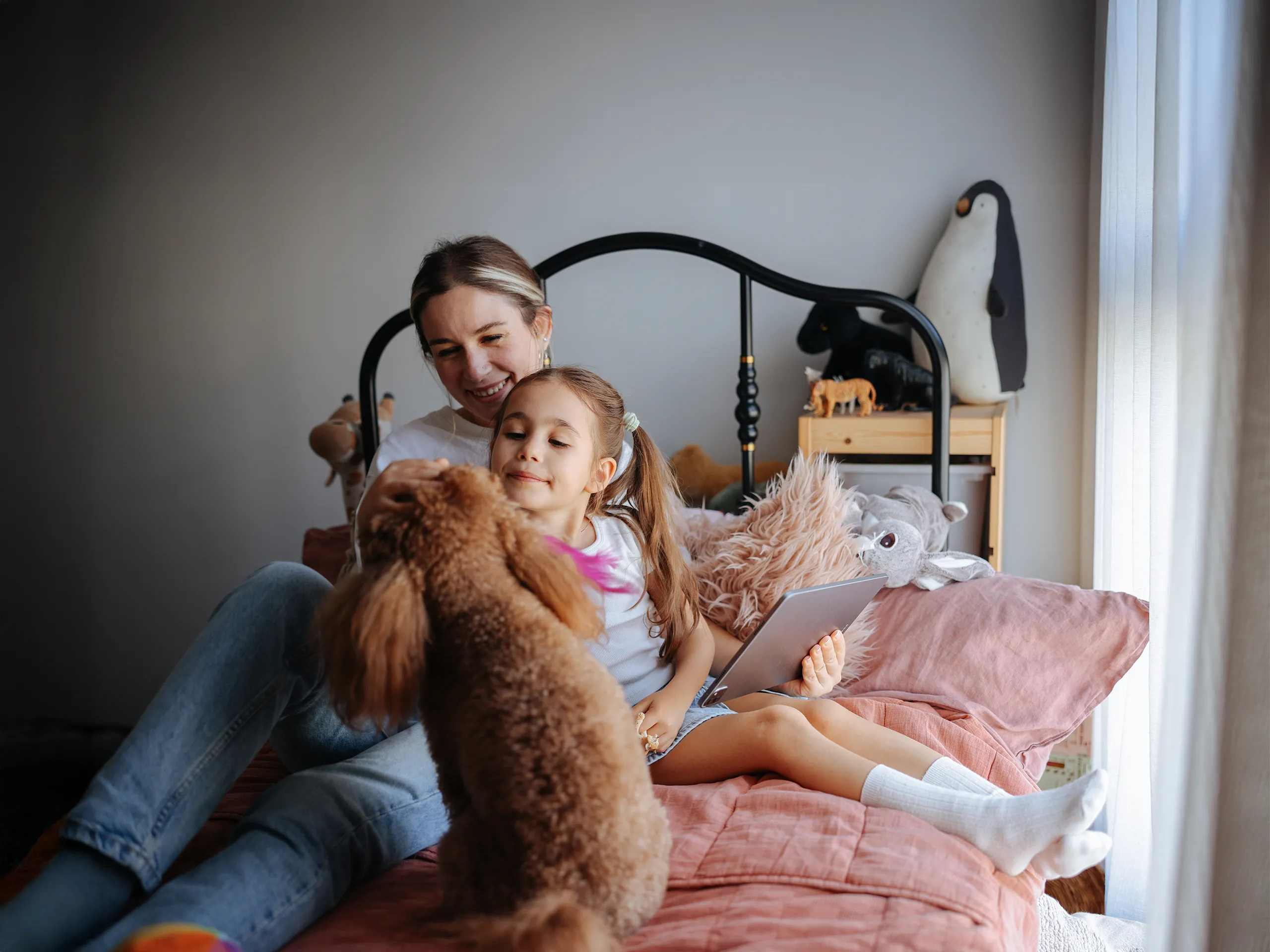Mother playing with baby on a play mat in the living room.
