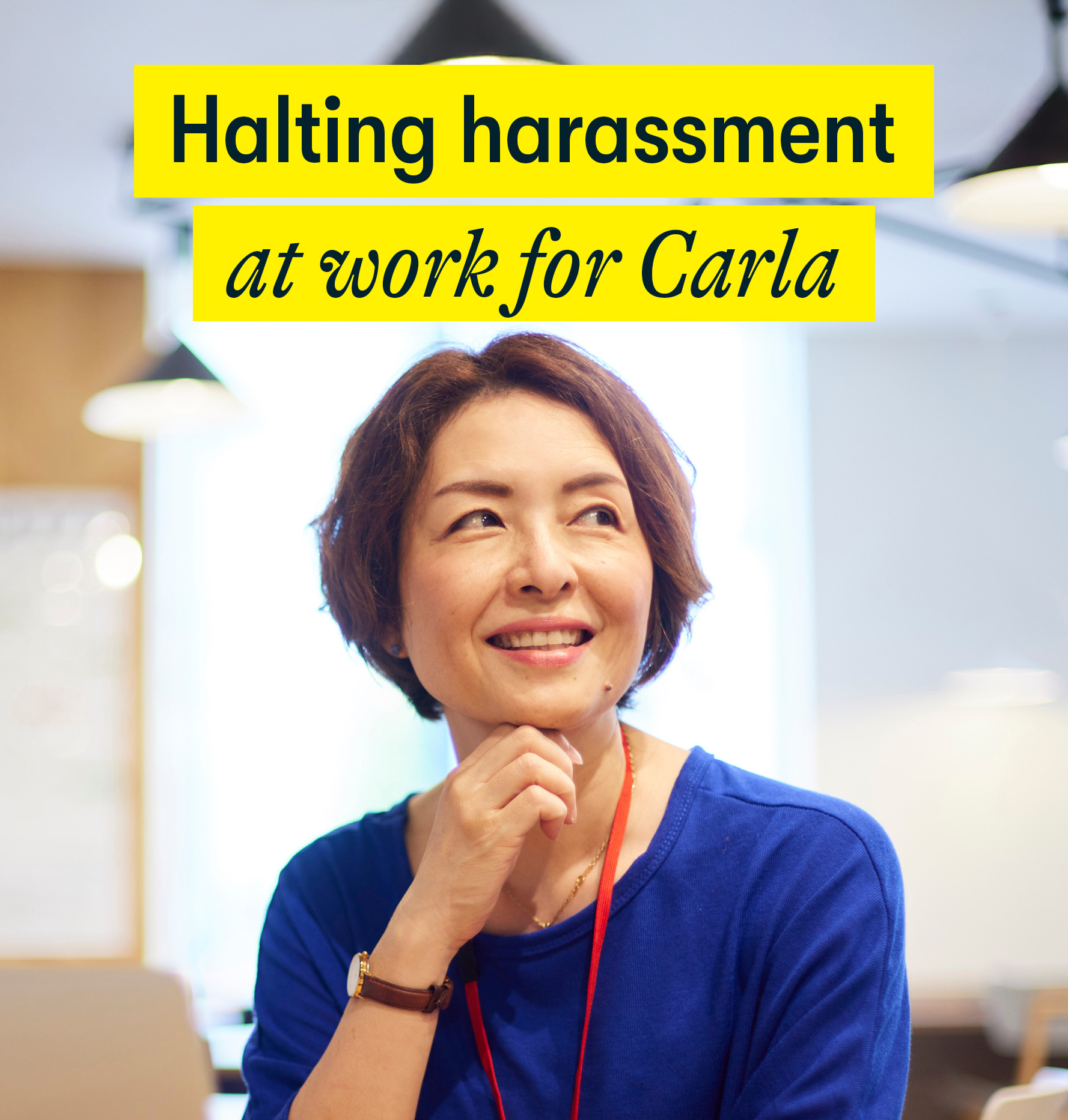 Halting harassment at work for Carla - a middle aged woman sits in an office looking happy