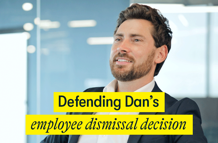 Defending Dan's employee dismissal decision Defending Dan's employee dismissal decision - an early 40s business man sits in his office smiling