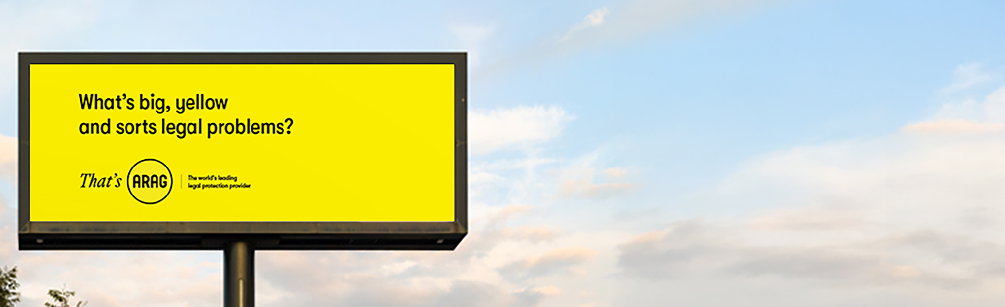 Header image with a roadside billboard. It is yellow with black writing - What's big, yellow and sorts legal problems? That's ARAG. The world's leading legal protection provider.