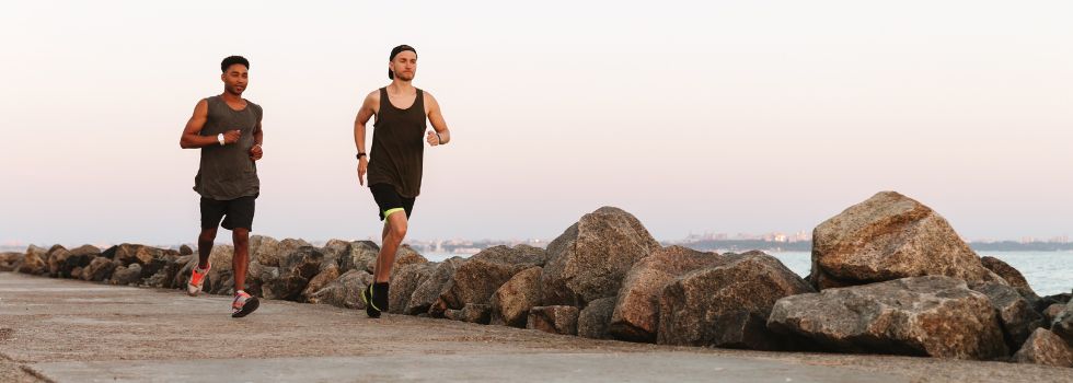Men running on a coastal path