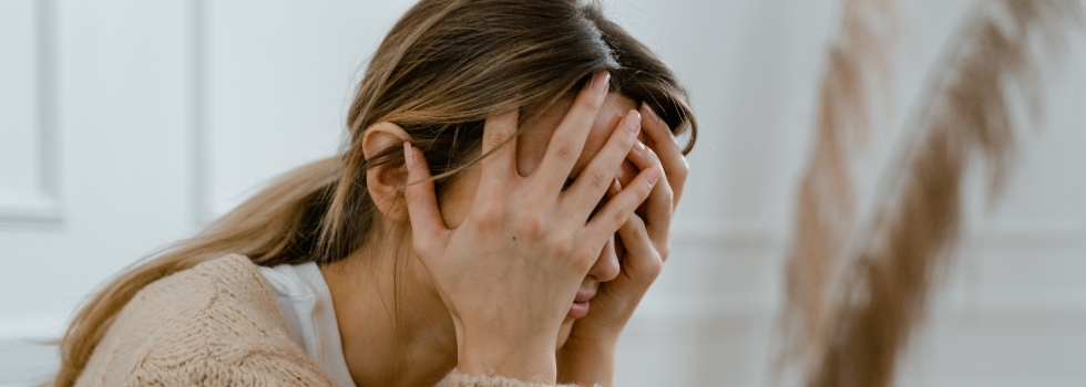 A woman holding her head