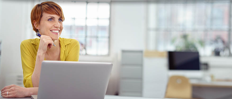 Smiling woman using laptop