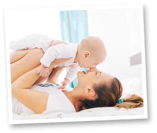 Family Legal Expenses Photo of a woman lying down holding a baby above her