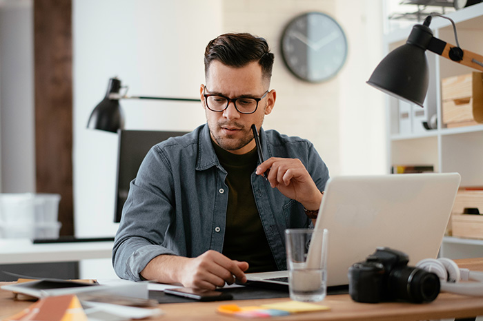 Young stressed handsome man working in office